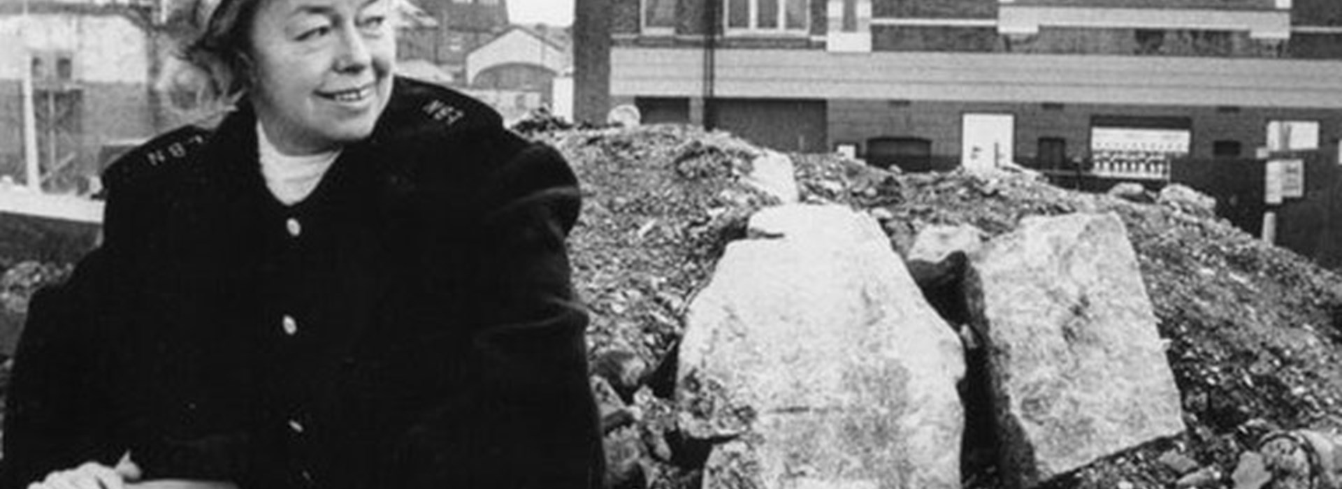 Joan Littlewood, surrounded by rubble following the regeneration of Stratford  during the 1960s.